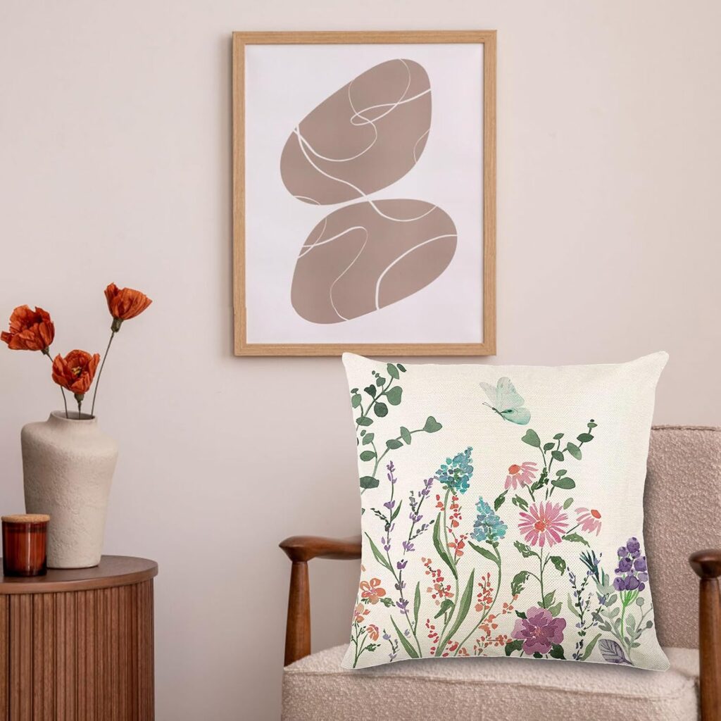 Decorative pillow with a floral pattern and a butterfly, placed in a stylish, minimal space with natural tones. no-save